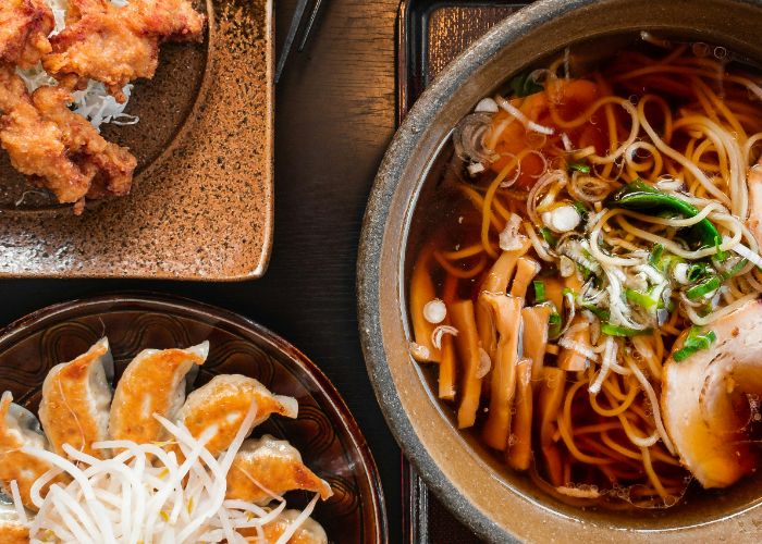 Ramen, gyoza, and karaage set on a table.